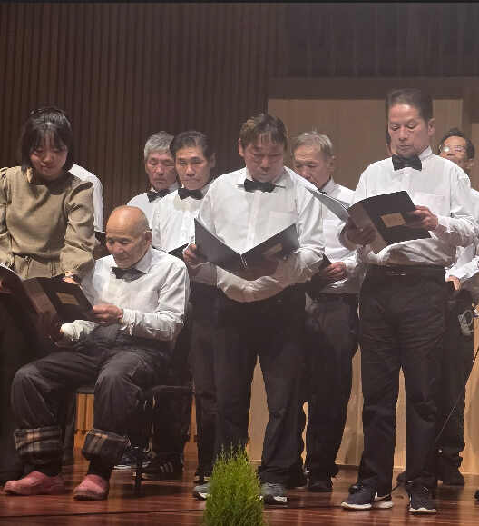 Older adults singing together on stage