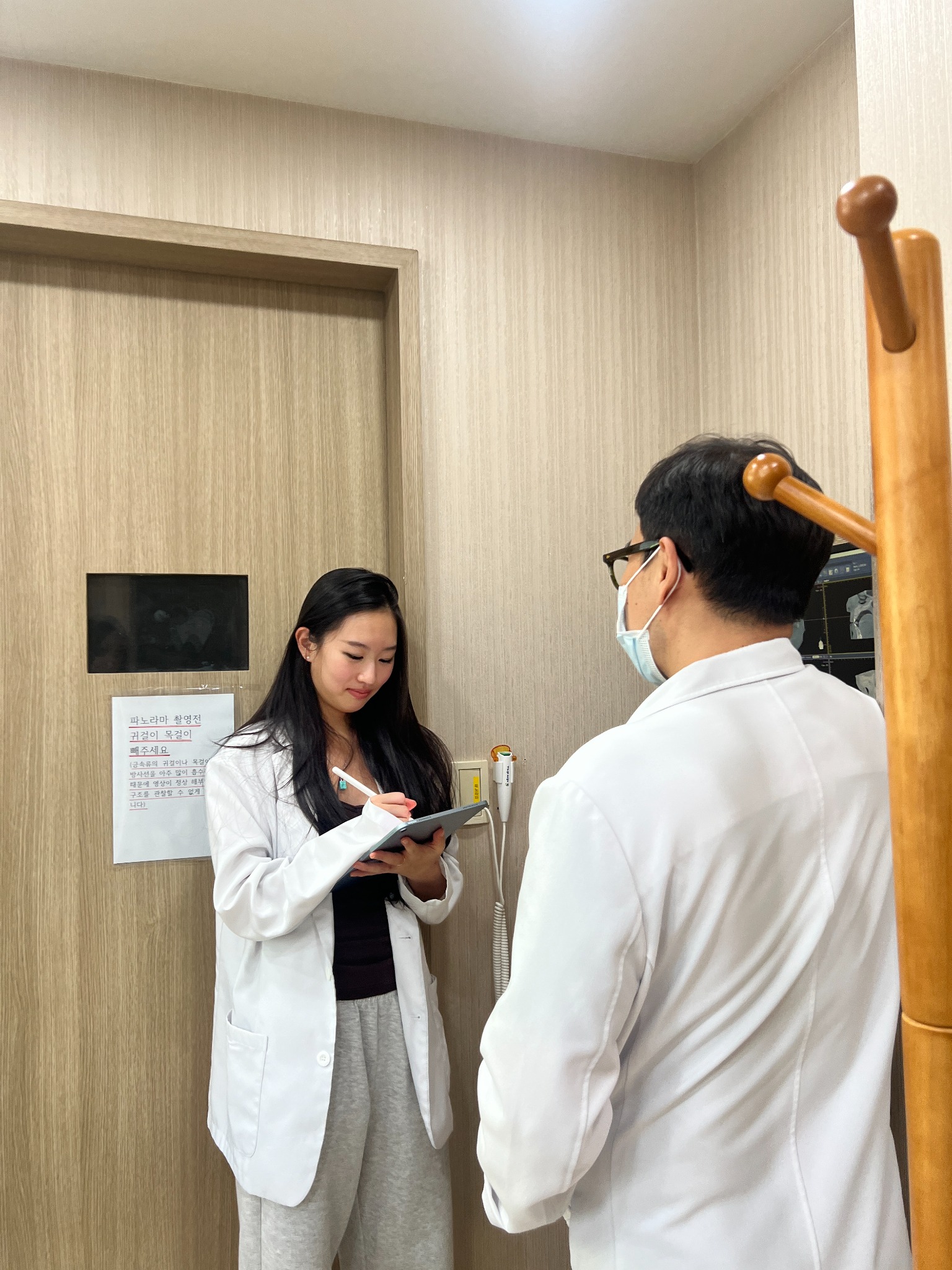 Grace observing a physician during clinical shadowing