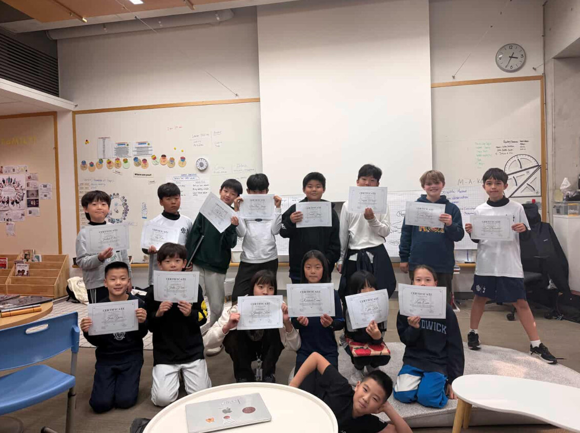 Coding Club students holding their completion certificates