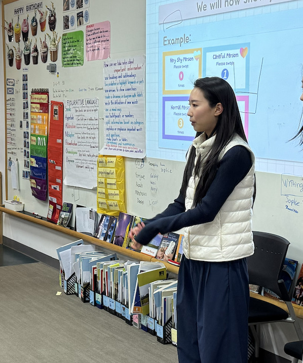 Grace presenting a coding activity to younger students