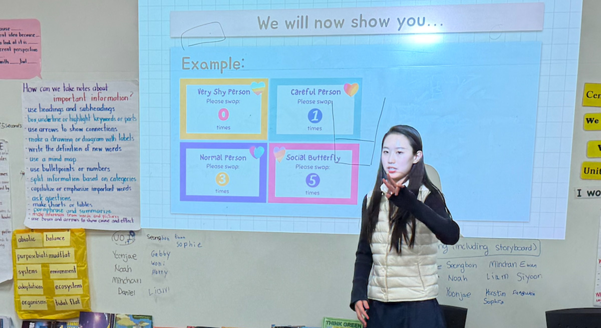 Grace presenting a coding lesson to younger students