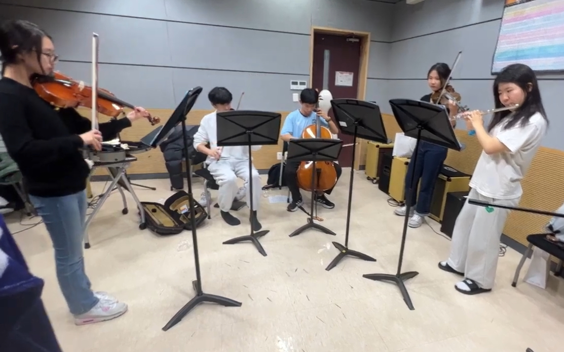 Crescendo student ensemble rehearsing together