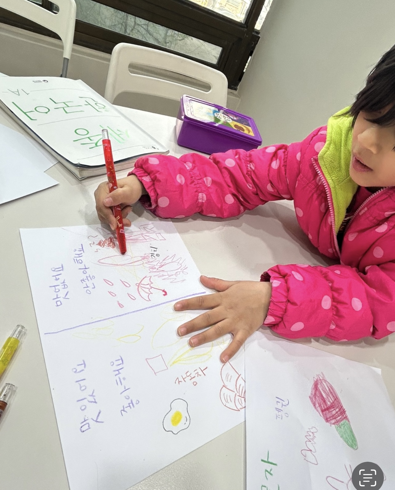 A child learning through art and writing