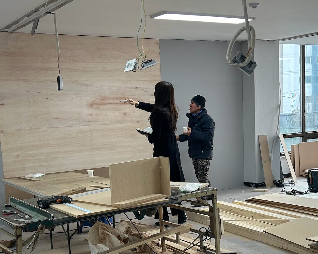 Grace discussing the restoration plan with a local contractor at the worksite