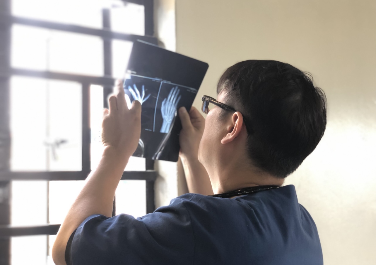 A physician examining an X-ray during field care