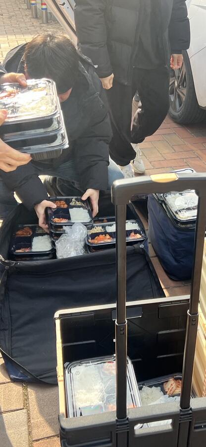 Volunteers organizing lunch boxes for delivery