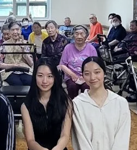 Grace and fellow student volunteers with nursing home residents