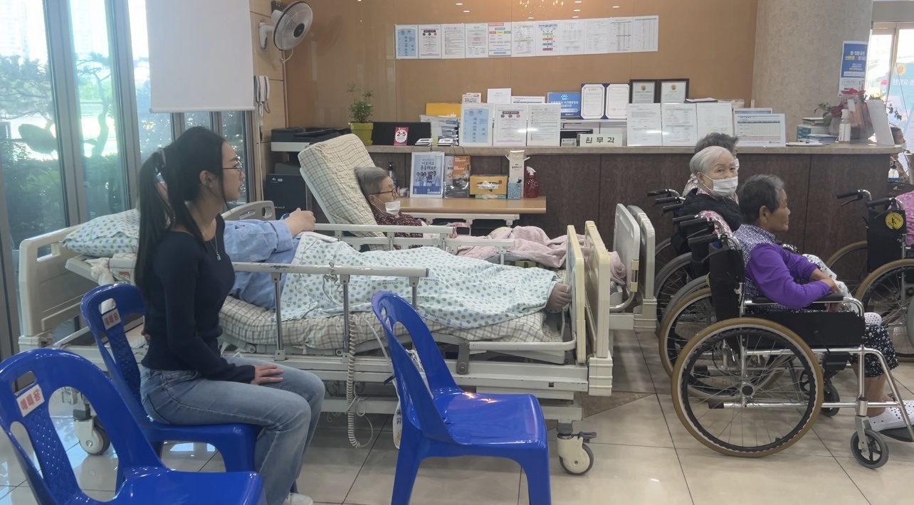 Grace spending time beside nursing home residents